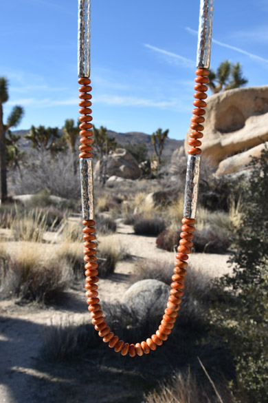 Necklace with apple coral rondelles and 925 silver also known as sterling silver tubes hand-hammered by Old World craftsmen in Vicenza, Italy from the Silver Stones collection by jewelry designer Kamila Kubelik