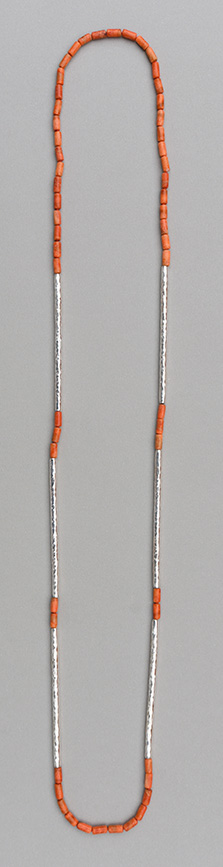 A necklace with six hammered 925 silver tubes of equal length combined with apple coral tubes